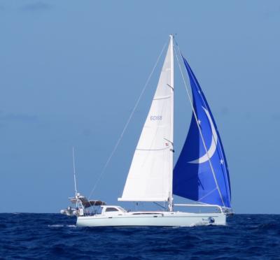 Light blue hull, Moon Shadow image on bow and blue headsail with moon